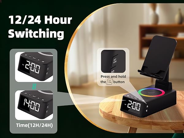 Text reads '12/24 Hour' and 'Switching'. Digital clock display device shown in black housing on wooden surface, featuring time display and control interface.