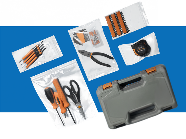 A flatlay of a toolbox and its tools. The tools are grouped and stored in five clear plastic bags.