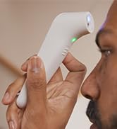 Close up of Microlife non-contact forehead thermometer taking temperature
