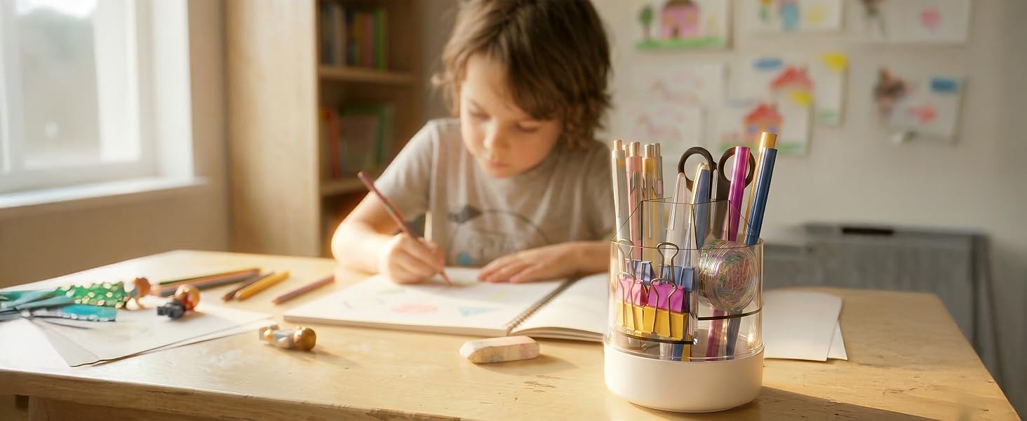 Writing desk scene with natural lighting, showing scattered pens and stationery materials on a wooden surface with soft, warm sunlight filtering through a window.