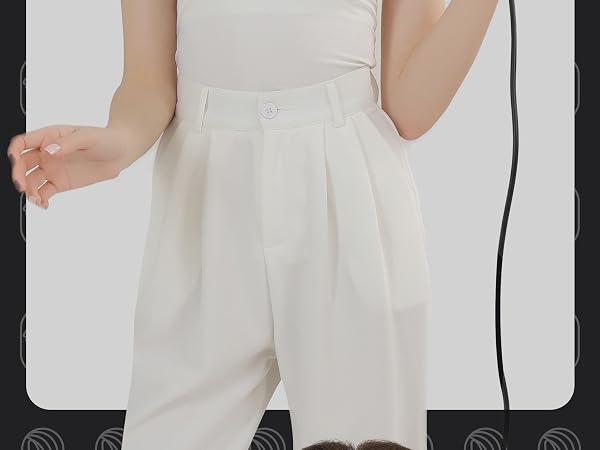 Close-up view of white high-waisted shorts or pants with pleated detail, showing partial side view of the garment.
