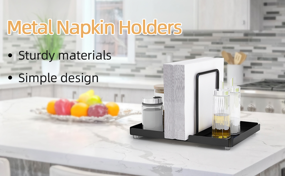 Metal napkin holders on kitchen counter. Features include sturdy materials and simple design. Set includes white holder and black tray with fruits and drink visible.