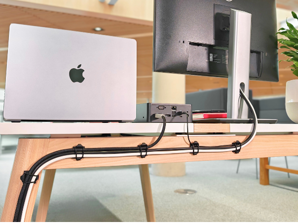 Proudct holding cables behind desk.