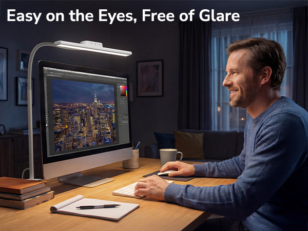 Text reads 'Easy on the Eyes, Free of Glare'. Person at desk using monitor with desk lamp, demonstrating anti-glare screen technology in evening setting.