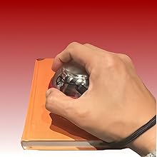 a hand holding a ball in a book
