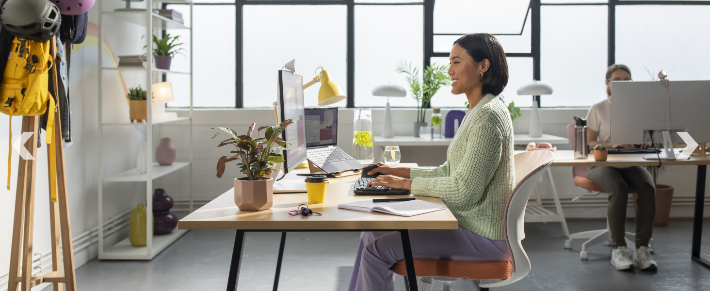 a woman typing on wave keys wireless ergonomic compact keyboard