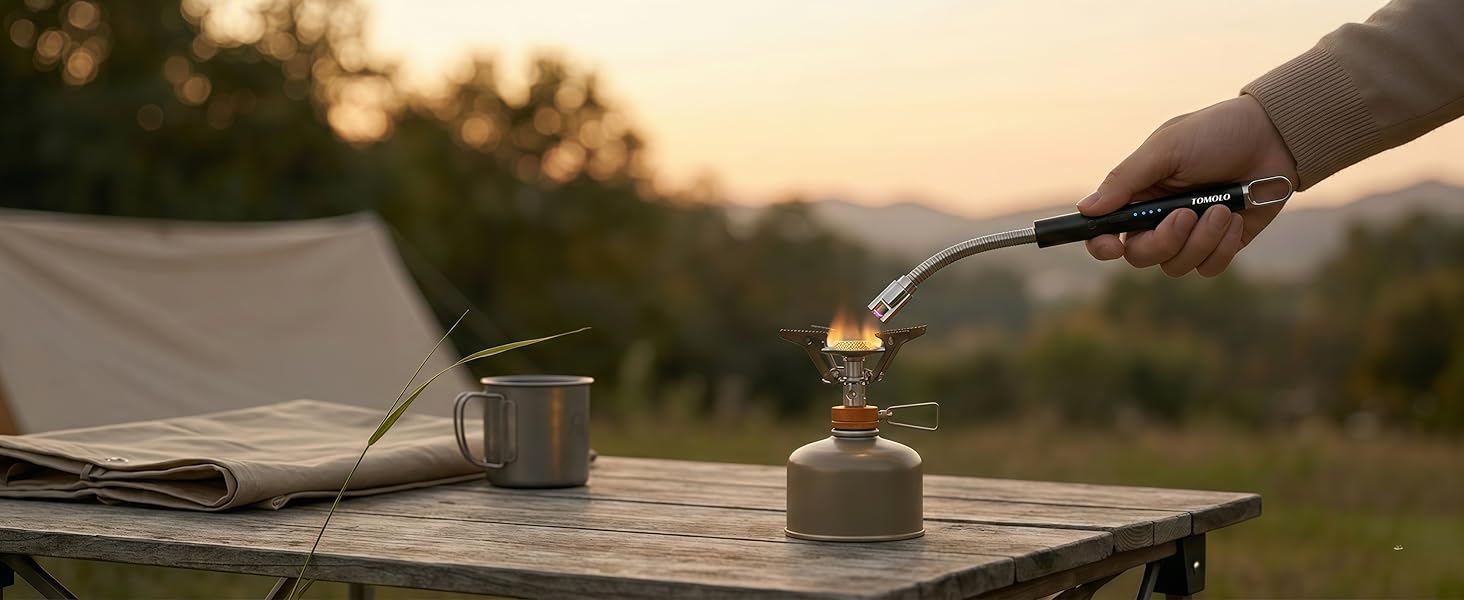 Electric arc lighter lighting a gas stove in kitchen