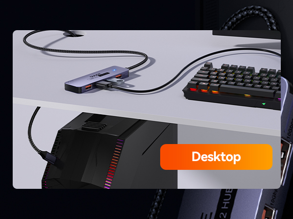 Text reads 'Desktop'. Gaming or computer setup showing partial view of keyboard with illuminated keys and other peripheral devices on dark surface.