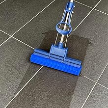 a blue vacuum cleaner on a tile floor.
