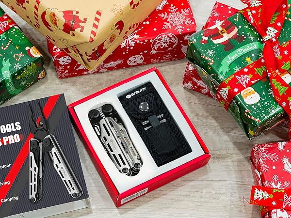 Multi-tool gift set in red box, surrounded by holiday-themed wrapped presents. Set includes folding multi-tool and black carrying case.