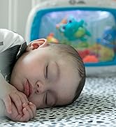 baby in crib in front of soother