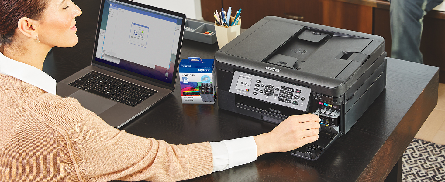 Person installing new LC401 ink cartridges into Brother printer