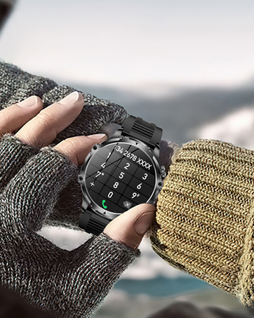Close-up of a hand wearing a gray knit glove holding a black smartwatch with a digital number dial display. A yellow knit sleeve is visible in the foreground.