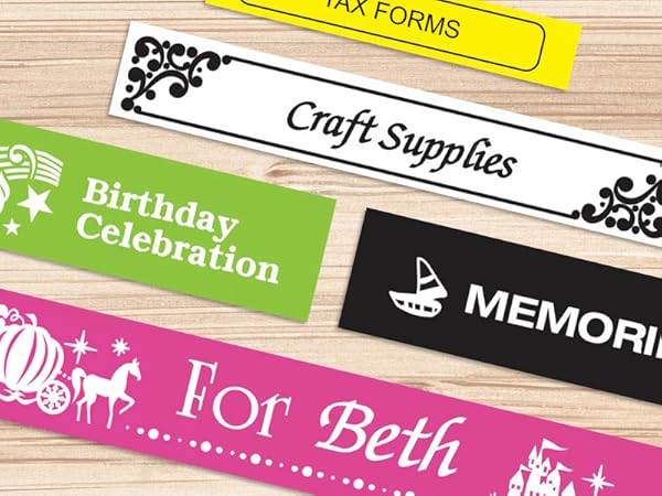 Different colored sample labels on a wood surface, with different fonts, symbols, and borders used