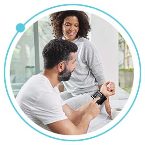 person using wrist blood pressure monitor