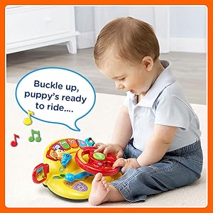 Kid pretends to drive with Turn &amp; Learn Driver. Toy sings: Buckle up, puppy’s ready to ride…