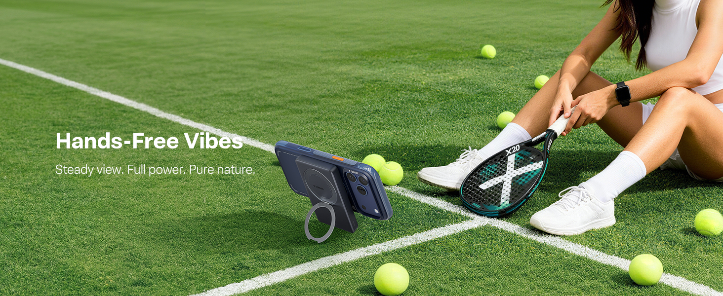 Woman with tennis racket uses phone on kickstand power bank.