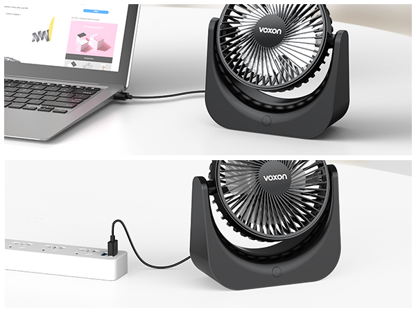 Small black USB desk fan shown connected to a laptop and plugged into a power strip. Features adjustable angle.