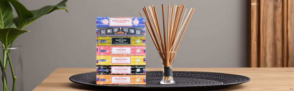 A wooden table with a lit incense stick and a trail of fragrant smoke rising from it, surrounded by 