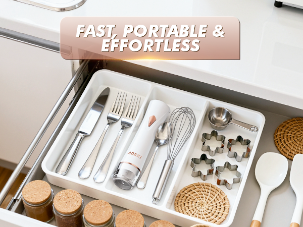 Handheld vacuum sealer stored in drawer with utensils, showing compact and easy-to-store design.