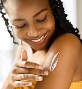 woman happily applying blue lizard after sun soothing lotion to her shoulder