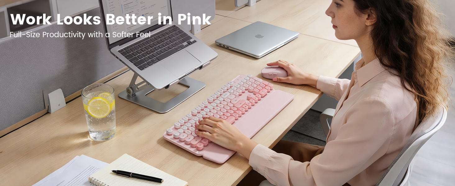 Pink wireless keyboard mouse combo on desk with laptop stand wrist rest for daily work