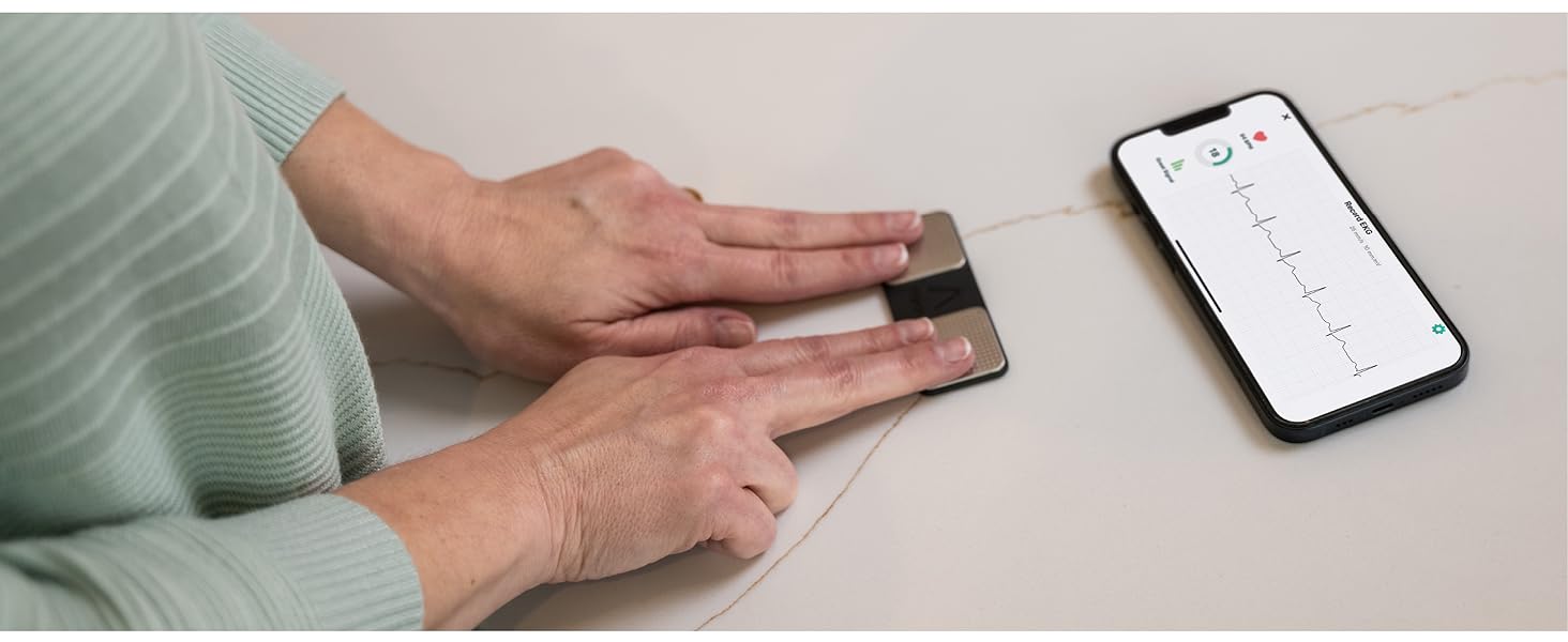 Person taking EKG with KardiaMobile heart monitor device and phone screen showing EKG recording