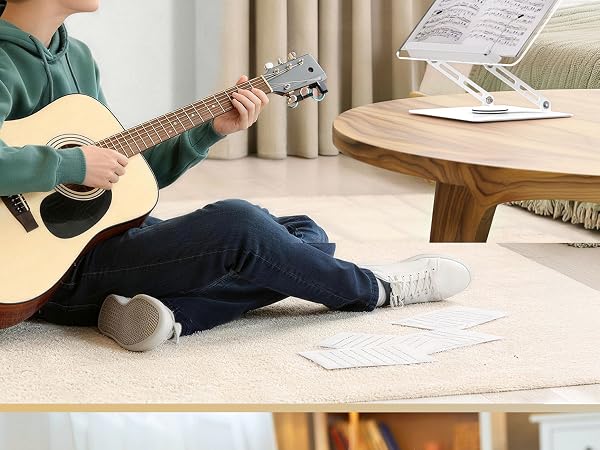 Multiple images showing a person relaxing on floor with acoustic guitar, demonstrating casual home music practice positions.