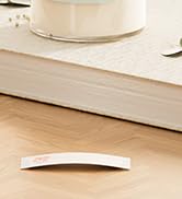 Partial view of what appears to be a beige or cream colored surface with minimal detail visible.