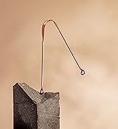 Arista’s copper tongue scraper balanced on a rock