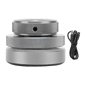 Multiple views of a circular metallic device with textured surface pattern. Shows different angles of what appears to be a silver-colored disc-shaped object with USB cable.