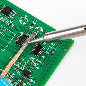 Close-up sequence showing electronic circuit board repair or assembly process. Green PCB board with soldering iron tip visible in some frames.