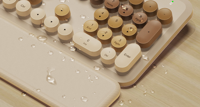 Water droplets on wireless keyboard and wrist rest showing splash resistant design easy wipe clean
