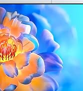 Extreme close-up of flower petals in orange tones against vibrant blue background, showing detailed texture and color gradients.