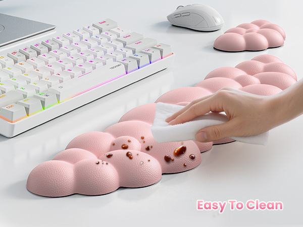 Pink silicone wrist rest with bubble-like texture. Hand demonstrating use next to keyboard with RGB lighting. White mouse and additional wrist rests visible. Text reads 'Easy To Clean'.