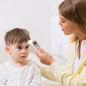 Point thermometer towards forehead, when it's within range it will automatically measure.