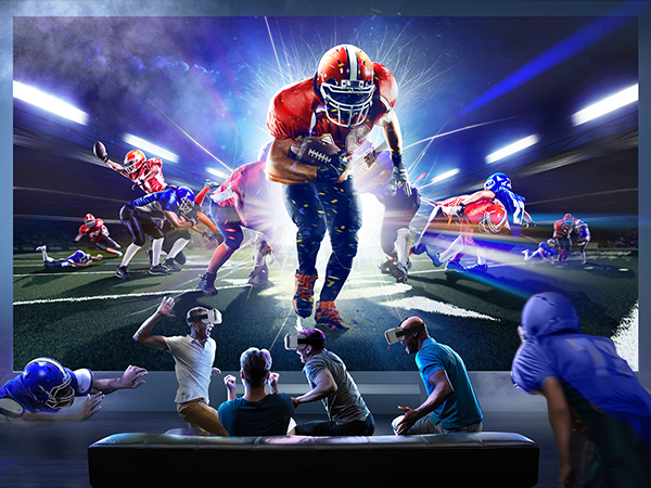 Football players in action on a field, with spectators watching on a screen. Dynamic scene with bright lighting and multiple players in motion.