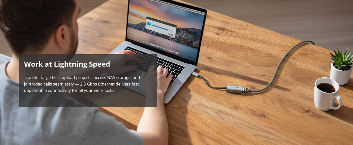 A Man Is Working and Transferring Files on MacBook Pro via USB-C to Ethernet adapter