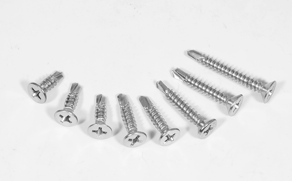 Collection of eight silver Phillips head screws arranged in a curved line, showing detailed threading and flat heads.