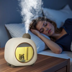 A woman sleeps peacefully as a cute animal-shaped humidifier on her nightstand emits gentle mist.