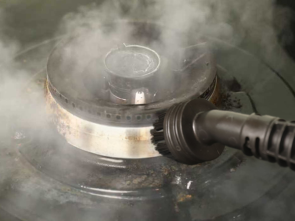 steam mop cleaning stove in kitchen