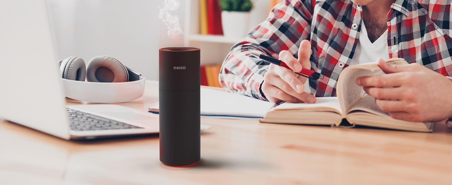 black portable air purifier sitting on desk