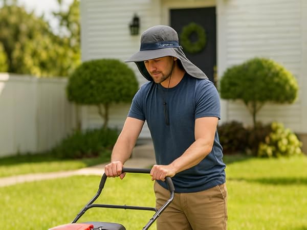 Man mowing lawn in backyard wearing TOP-EX sun hat with neck flap for sun protection in yard