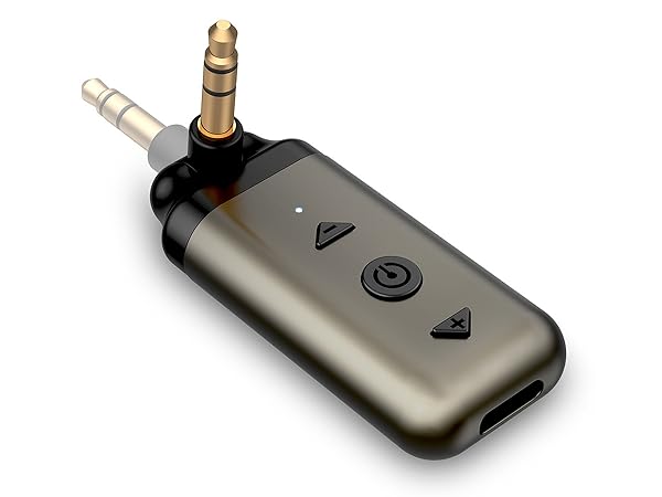 Small metallic device with 3.5mm audio jack and control buttons. Likely a portable audio adapter or receiver.