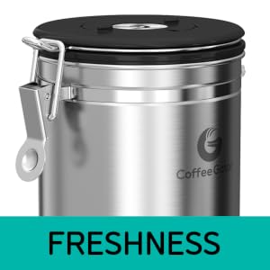 Close up of a silver coffee canister with a black lid