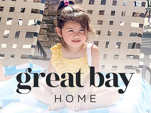 Little girl smiling on beach chair covered in beach towel made by Great Bay Home