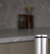 Close-up of a cylindrical silver metal object, possibly a fixture or hardware component, against a blurred background.