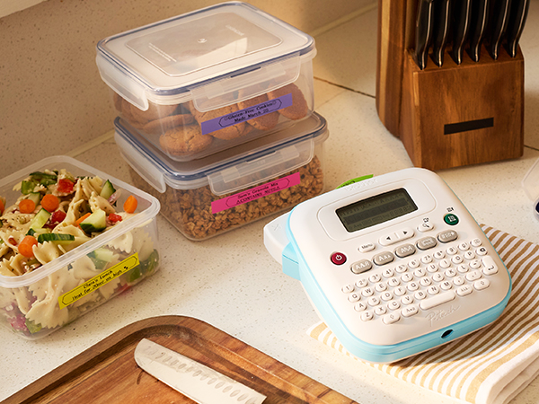 Brother P-touch PT-N25BTV3 label maker on kitchen countertop, next to labelled meal prep containers