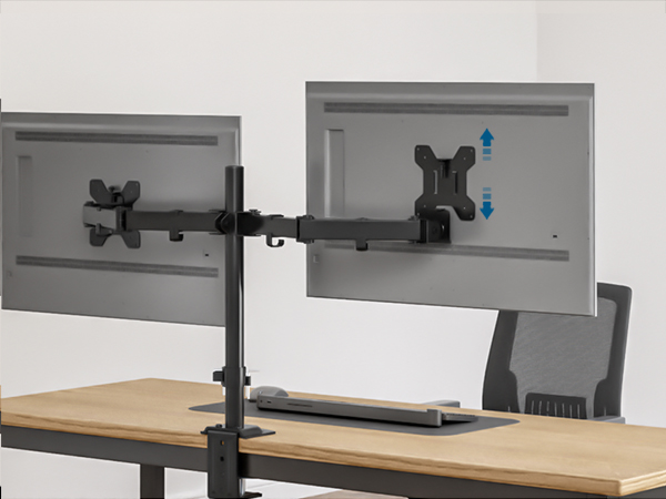 Dual monitor mount attached to desk, supporting two computer screens. Adjustable arms allow vertical movement of right monitor.