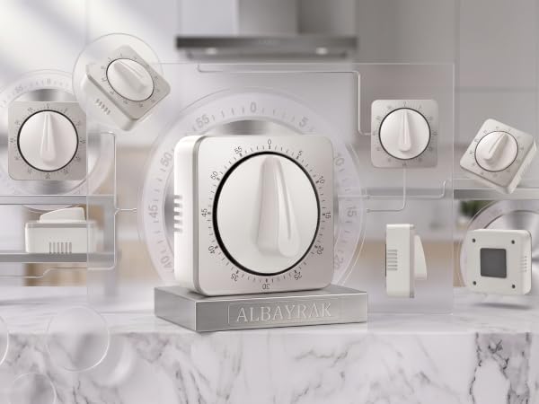 Square mechanical kitchen timer with white dial on marble counter with abstract frames.